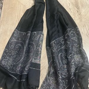 Black pashmina scarf with a colorful shimmer at the bottom.